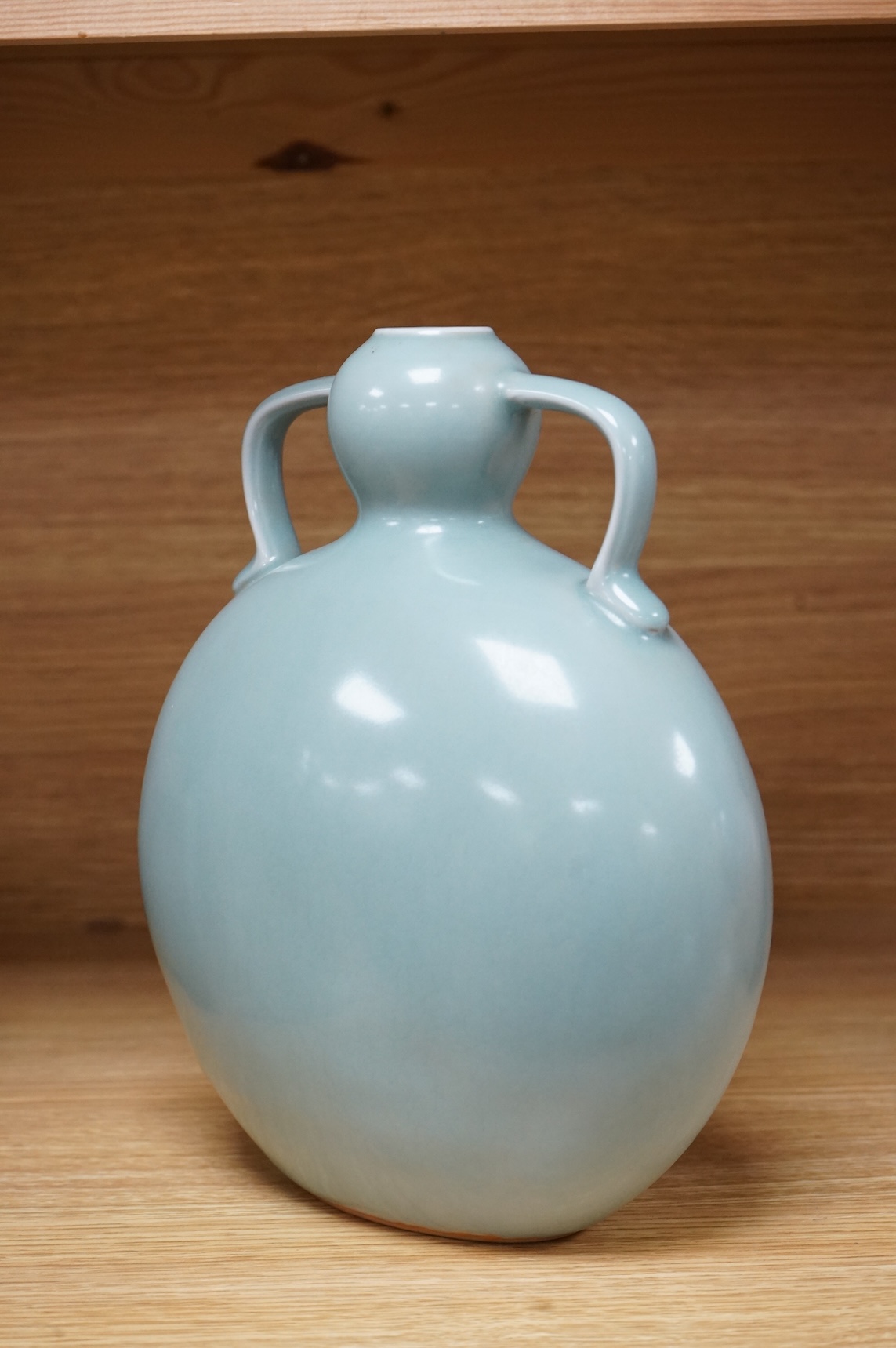 A Chinese celadon glazed two handled moon vase, 24cm high